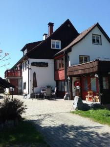 a large white building with a patio in front of it at Haus Biggi - Ferienwohnung Säntis in Weiler-Simmerberg