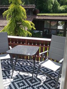 a table and two chairs on a patio at Haus Biggi - Ferienwohnung Säntis in Weiler-Simmerberg