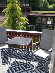 a table and two chairs on a patio at Haus Biggi - Ferienwohnung Säntis in Weiler-Simmerberg +9 photos