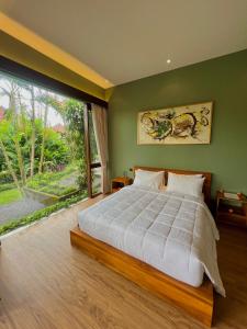 Postel nebo postele na pokoji v ubytování Ardan Maison Ubud