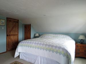 a bedroom with a bed and a wooden door at 3 Bed in Boscastle 75145 in Boscastle