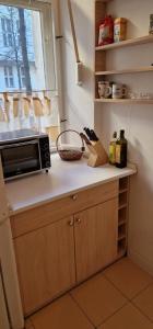 a kitchen counter with a microwave and a window at Appartement Berlin Charlottenburg in Berlin