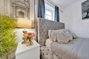 a bedroom with a bed and a table with a vase of flowers at Large 1 Bed Apartment by London Bridge Tower Bridge Secure Parking - Perfect for Long Stays in London