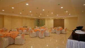 a banquet hall with tables and chairs in a room at Hotel Park Street in Pathānkot