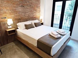 ARIQUS Fira Apartments客房内的一张或多张床位