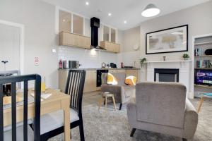 a living room and kitchen with a table and chairs at Spacious homely 1 Bed Apartment in Hartlepool in Hartlepool