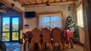a dining room with a table and a christmas tree at Casa Bună Fundățica in Fundăţica