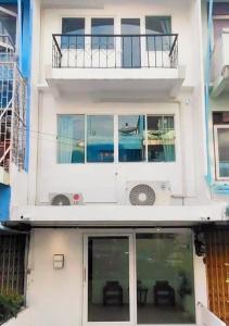 a white house with windows and a balcony at Whole 3-storey house right in the local community. in Bangkok