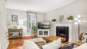 a living room with a couch and a fireplace at 4-bedroom Bliss With Downtown Proximity in Greensboro