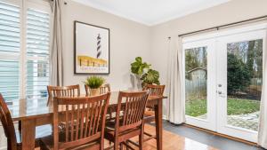 a dining room with a wooden table and chairs at 4-bedroom Bliss With Downtown Proximity in Greensboro