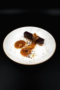 a white plate with a piece of chocolate on it at Lyngen North in Rotsund
