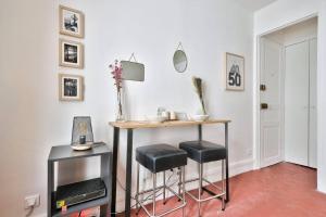 a room with a table and two stools and a table at Wonderful Studio at Place de la Bastille in Paris