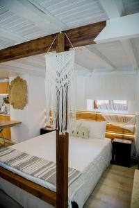 a bedroom with a wooden bunk bed with white sheets at YARD- Family retreat in Kórinthos