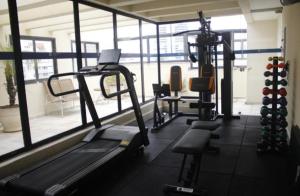 a gym with a treadmill and exercising equipment and a window at Executive Flat Bela Cintra 704 in Sao Paulo