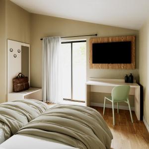 a bedroom with a bed and a desk and a television at Residence San Michele in Costermano