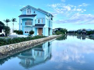 a blue house next to a river at An Blue House in Dazhou