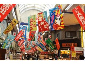 a store with colorful signs hanging from the ceiling at Akashi Castle Hotel - Vacation STAY 83573 in Akashi