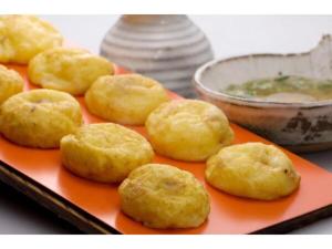 a plate of donuts on an orange plate with a bowl of soup at Akashi Castle Hotel - Vacation STAY 79268 in Akashi