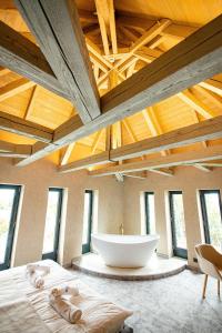 a large bathroom with a large tub in a room with windows at Bordűr Wellness Hotel Superior és Szőnyegmúzeum in Békésszentandrás