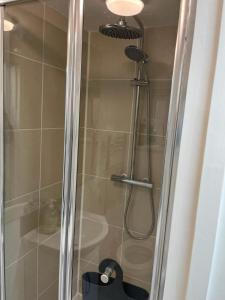 a shower in a bathroom with a glass door at Cozy Guest Room in High Barnet (London) with Private Entrance and Small Terrace in London