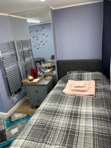 a bedroom with a bed with a sink and a mirror at Cozy Guest Room in High Barnet (London) with Private Entrance and Small Terrace in London