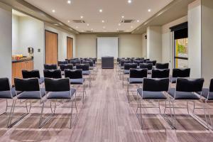 a conference room with chairs and a podium at City Express by Marriott Piedras Negras in Piedras Negras