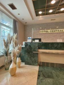 a hotel terminal with a reception desk and vases at Hotel Central in Zagreb