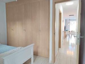 a bedroom with wooden cabinets and a dining room at Magec Holiday Tenerife in San Miguel de Abona