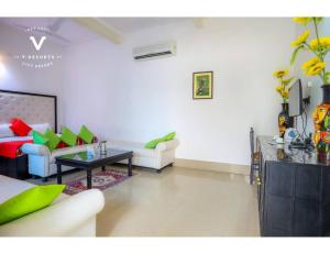 a living room with a couch and a table at Hotel Kiran Villa Palace, Bharatpur in Bharatpur