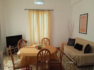 a living room with a table and a couch at Serene Country House (near Ancient Tiryns) in Nafplio