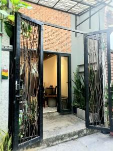 an open glass door of a building with plants at ZVillage NCC - Modern Townhouse in District 1 in Ho Chi Minh City