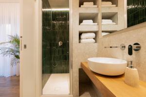 a bathroom with a sink and a shower at Riviera Suites in Civitavecchia