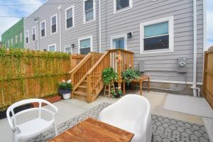 a patio with a wooden deck and a house at Beautiful Home w/ Rooftop Deck Within A 5 Mintue Walk To Johns Hopkins Hospital in Baltimore