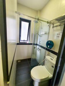 a bathroom with a toilet and a glass shower at ZVillage NCC - Modern Townhouse in District 1 in Ho Chi Minh City