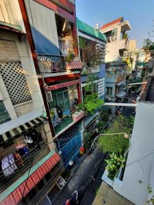 an overhead view of a building with people on a balcony at ZVillage NCC - Modern Townhouse in District 1 in Ho Chi Minh City