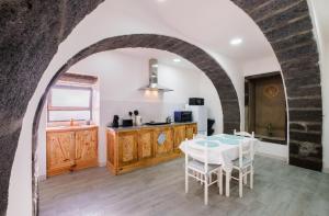 a kitchen and dining room with a table and chairs at Castanheiro's Place in Ponta Delgada
