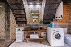 a bathroom with a sink and a washing machine at Castanheiro's Place in Ponta Delgada