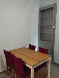 a dining room table with chairs and a cabinet at Pegasus Blossom in Korinthos