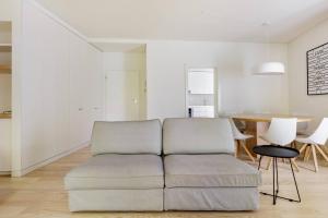 a living room with a couch and a table at MY LX FLAT Avenida da Liberdade A in Lisbon