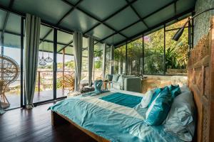 um quarto com uma cama num quarto com janelas em Selini Hills em Labuan Bajo