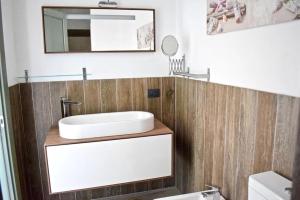 a bathroom with a sink and a mirror at Harbor Houses II in Marzamemi