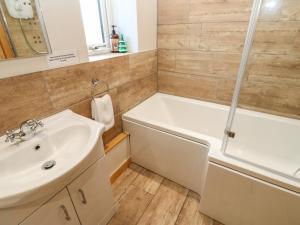 a bathroom with a tub and a sink and a shower at Dale View in Bishop Auckland