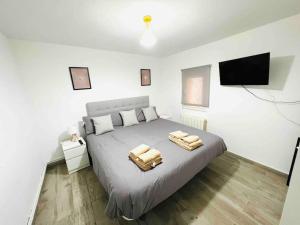 a bedroom with a bed and a flat screen tv at Apartamento Luna in Montgat