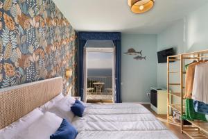 a bedroom with a bed with a wall mural at Hotel Villa Lubrense Sorrento in Massa Lubrense