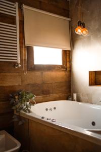 a bath tub in a bathroom with a window at Casa MUKAU Buenos Aires in Buenos Aires +17 photos
