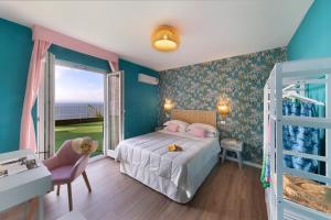 a bedroom with a bed and a balcony at Hotel Villa Lubrense Sorrento in Massa Lubrense