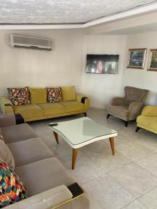 a living room with couches and a coffee table at Serenity suites Hotel in Antalya