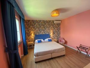 a bedroom with a bed in a room with red walls at Hotel Villa Lubrense Sorrento in Massa Lubrense