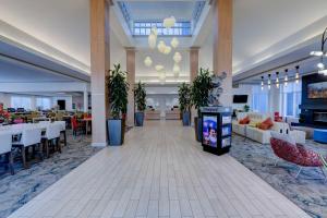 a lobby of a hotel with tables and chairs at Hilton Garden Inn Anaheim/Garden Grove in Anaheim