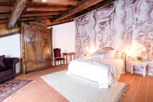 a bedroom with a bed and a wall mural at La Celeste Galeria in Mantova